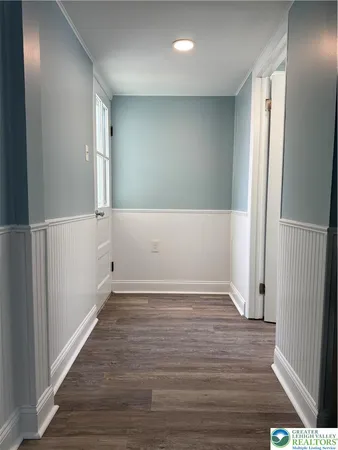 an empty room with wooden floor