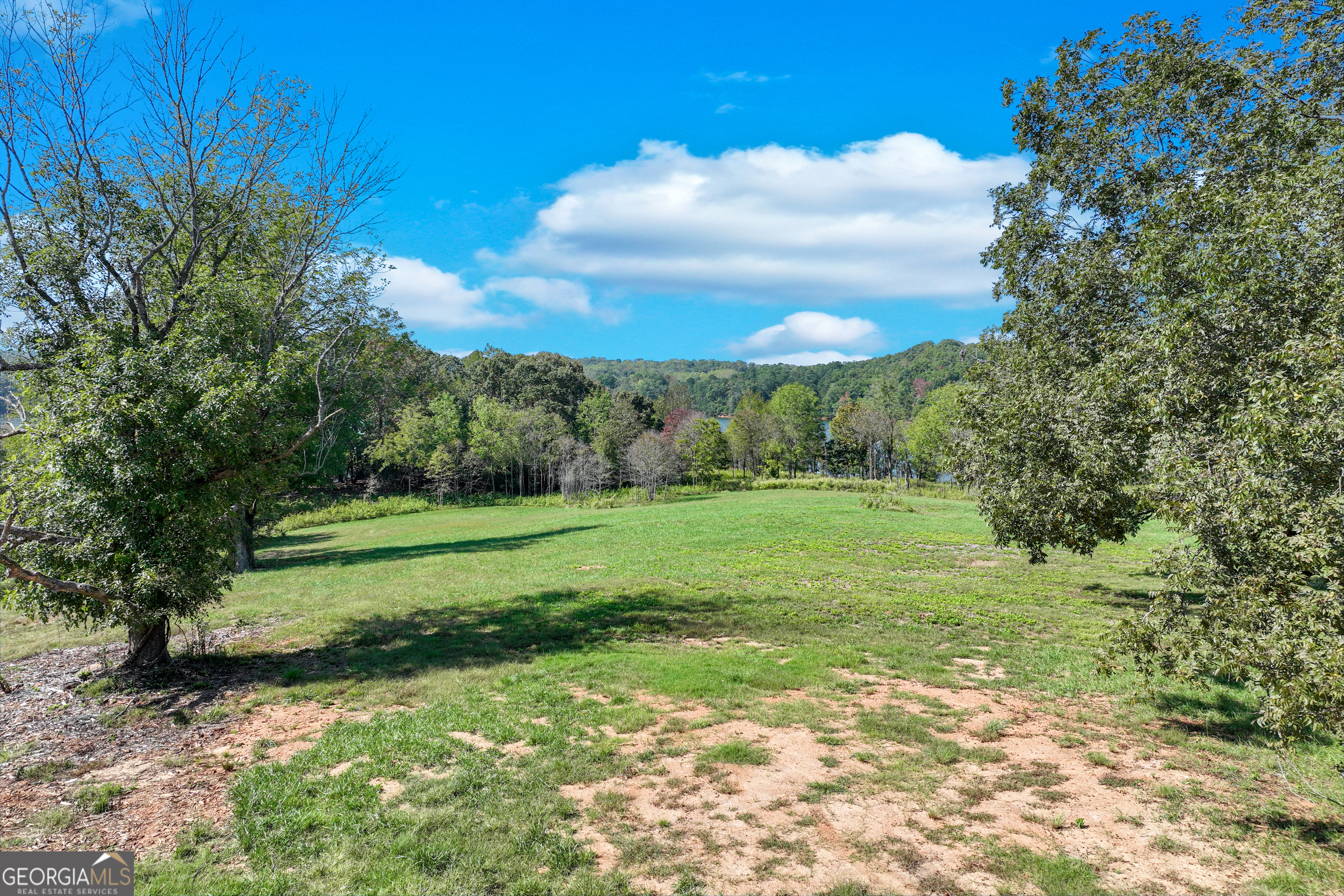 4638 Shirley Road, Unit LOT 2 Gainesville, GA 30506 - Photo 13 of 22 a view of a grassy field with trees in the background