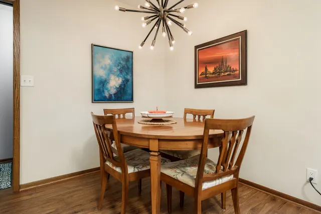 a living room with furniture a rug a lamp and a large window