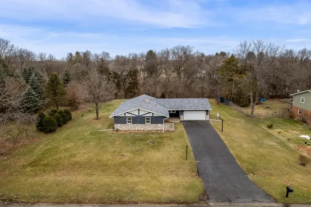 a view of a swimming pool with a yard and trees in the background