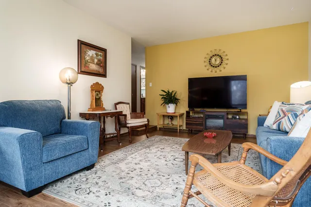 a bedroom with a bed and a lamp on dresser