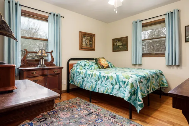 a bedroom with a bed and a large window