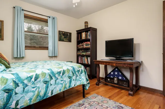 a bedroom with a bed and a flat screen tv