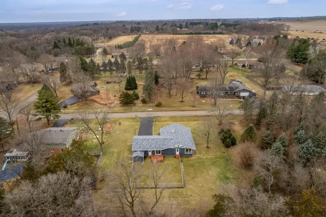a view of a dry yard with trees