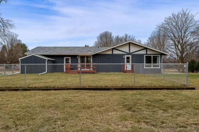 a view of a field with trees in the background