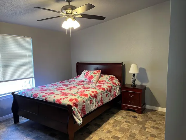 a bed sitting in a bedroom next to a window