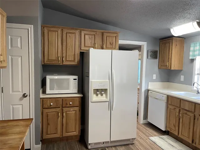 a white refrigerator freezer sitting inside of a kitchen