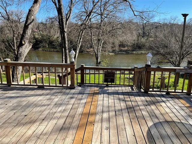 a view of balcony with wooden floor and outdoor seating