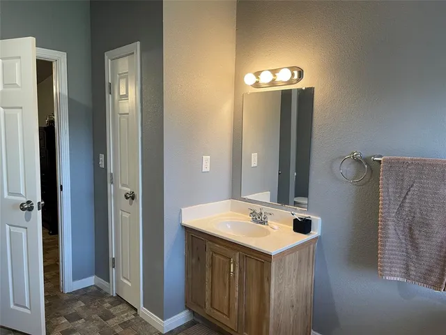 a bathroom with a sink vanity and a mirror