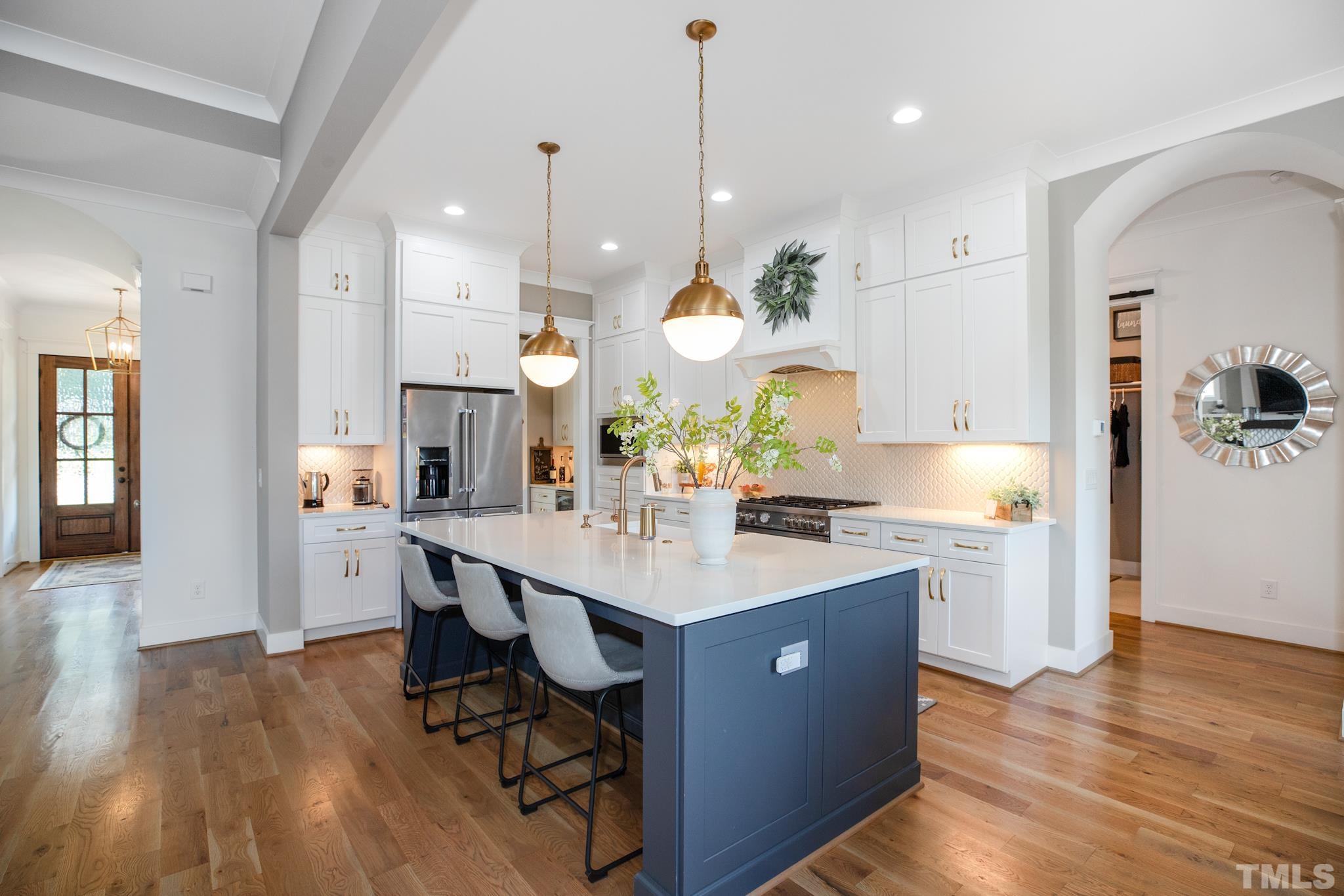 1420 Margrave Drive Wake Forest, NC 27587 - Photo 16 of 30 a large kitchen with stainless steel appliances a large center island attached withe living room