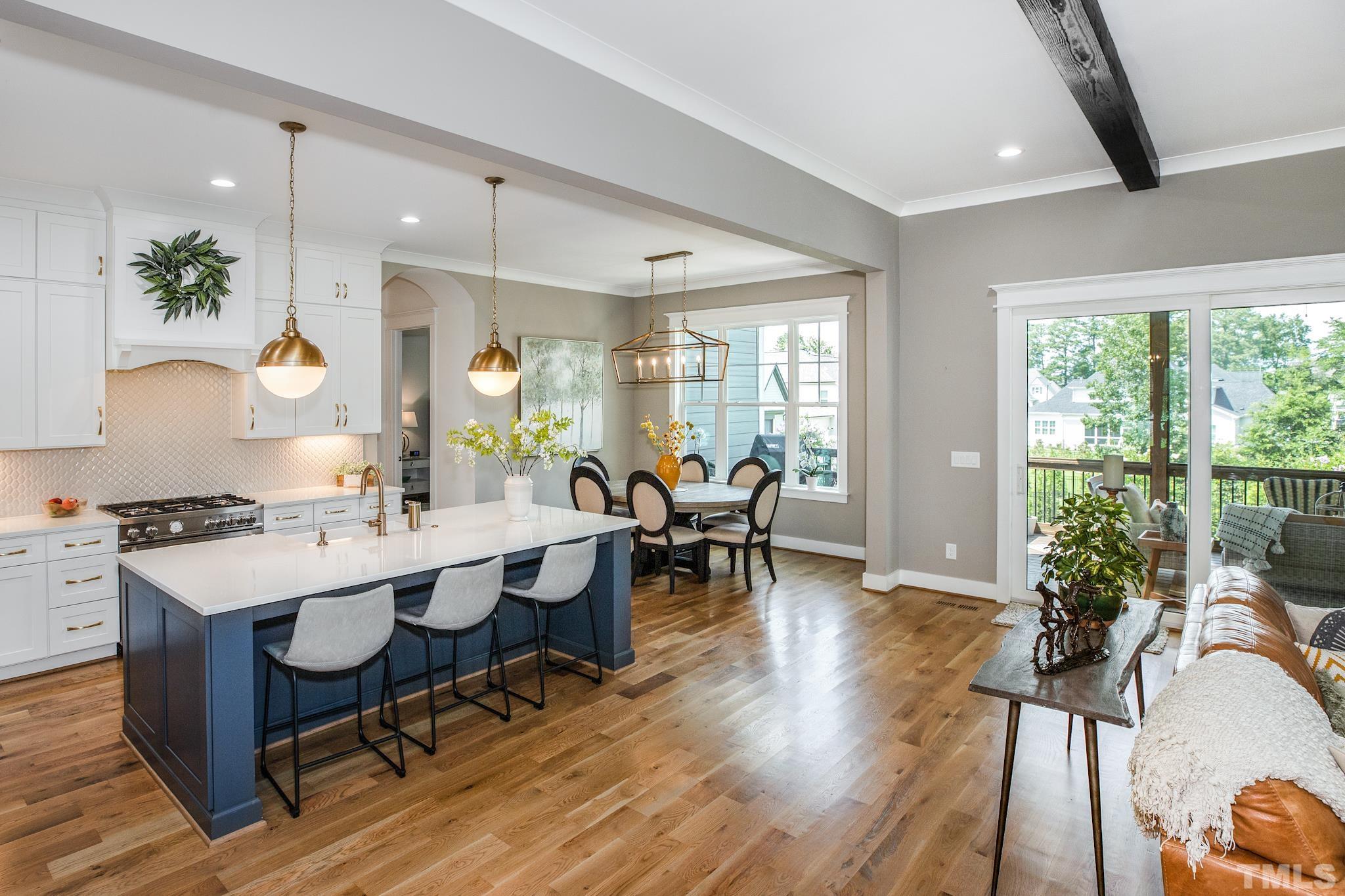 1420 Margrave Drive Wake Forest, NC 27587 - Photo 17 of 30 a very nice looking dining room with a large window wooden floor and stainless steel appliances