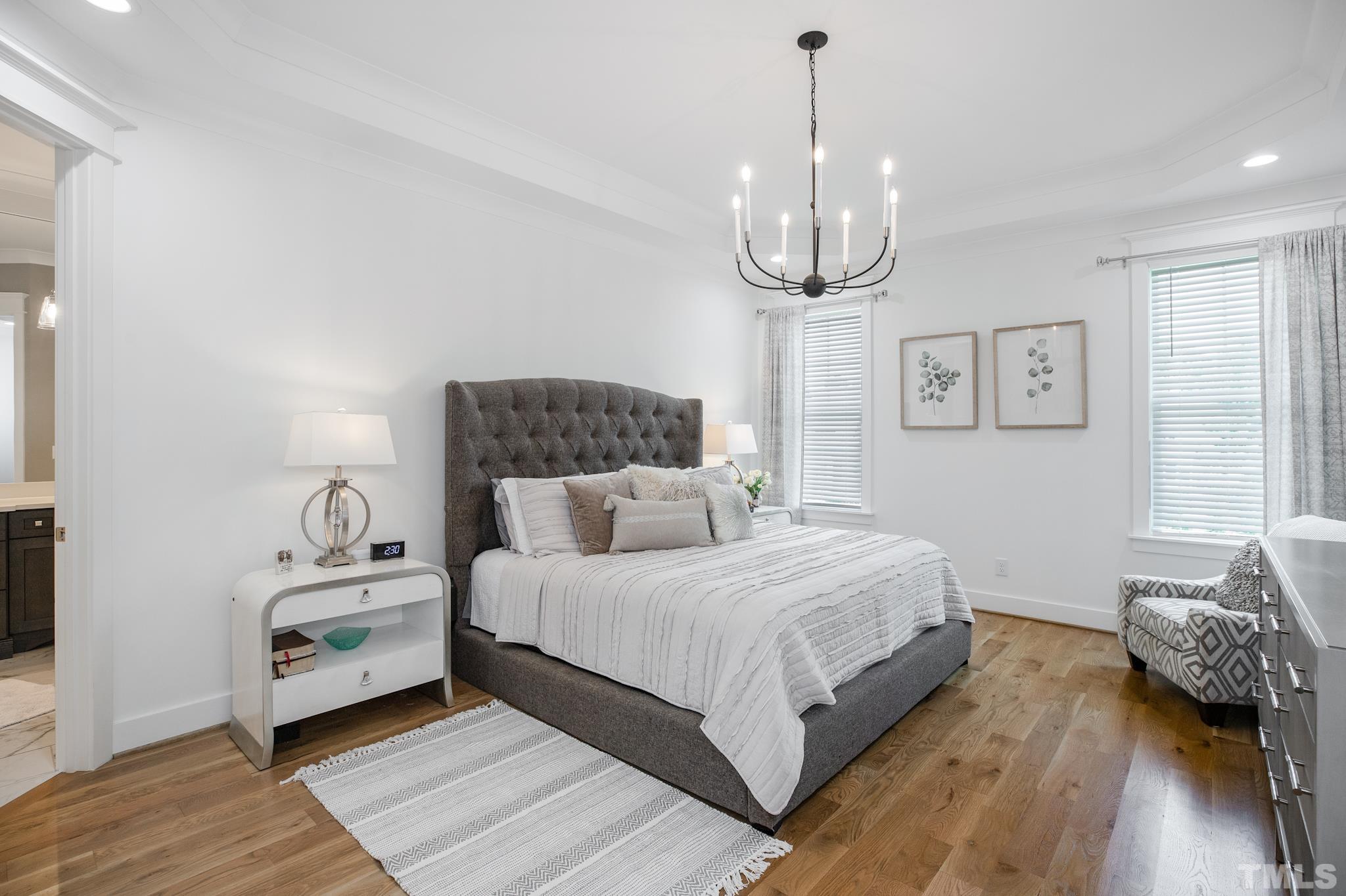 1420 Margrave Drive Wake Forest, NC 27587 - Photo 19 of 30 a bedroom with a bed and wooden floor