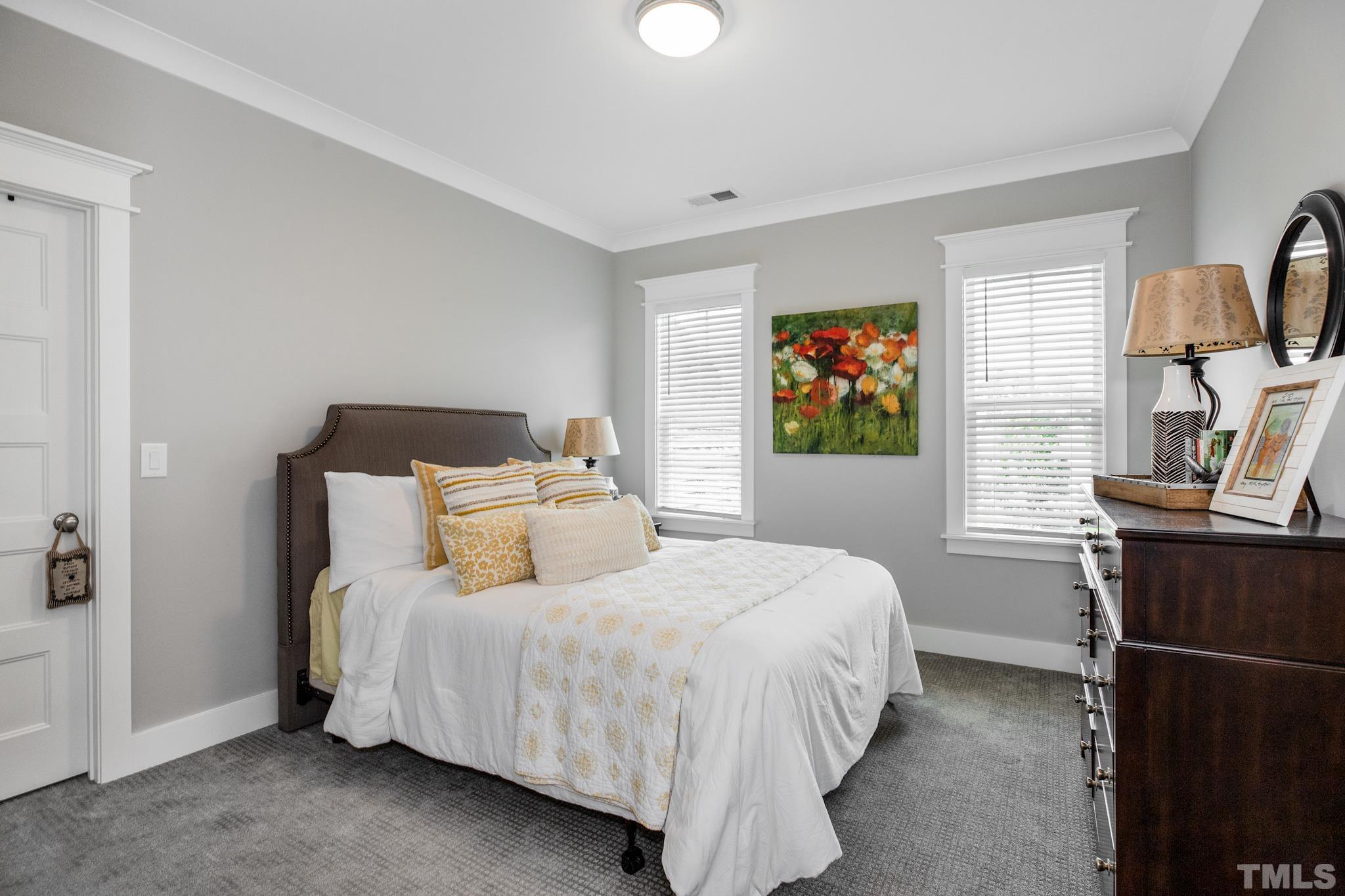 1420 Margrave Drive Wake Forest, NC 27587 - Photo 27 of 30 a bedroom with a bed and wooden floor