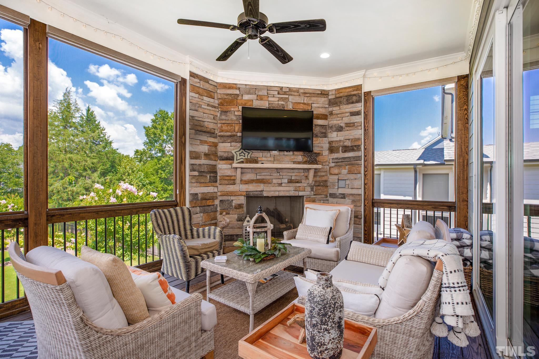 1420 Margrave Drive Wake Forest, NC 27587 - Photo 6 of 30 a living room with furniture a fireplace and a floor to ceiling window