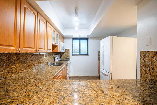 a kitchen with stainless steel appliances granite countertop a stove and a sink