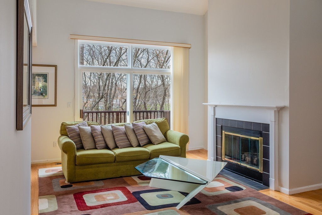 85 Bishops Forest Drive, Unit 85 Waltham, MA 02452 - Photo 11 of 32 a living room with furniture and a fireplace
