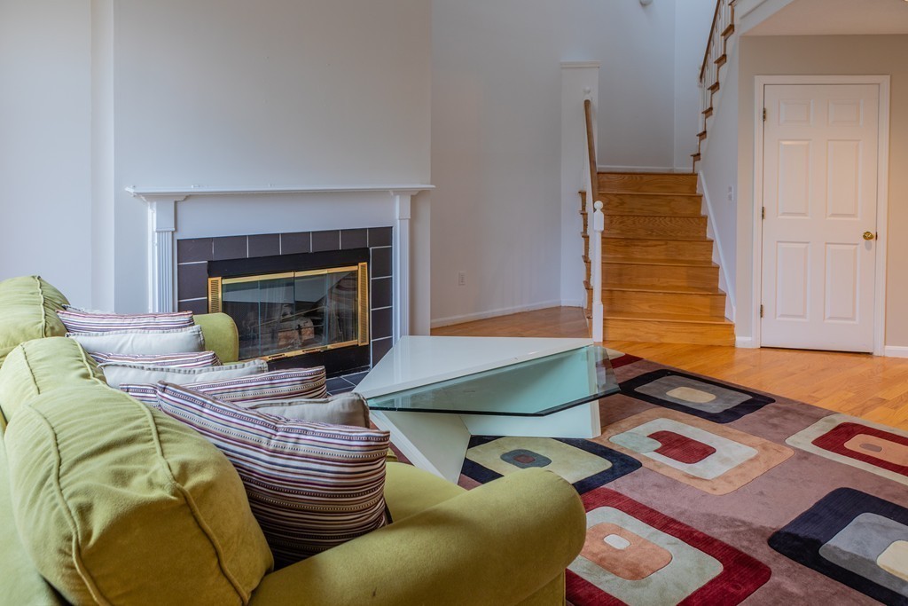 85 Bishops Forest Drive, Unit 85 Waltham, MA 02452 - Photo 13 of 32 a living room with furniture and a fireplace