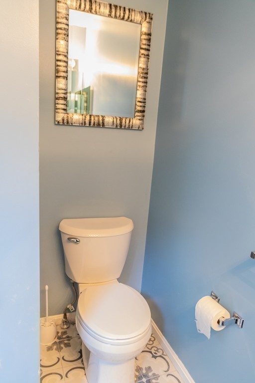 85 Bishops Forest Drive, Unit 85 Waltham, MA 02452 - Photo 22 of 32 a bathroom with a toilet and a mirror