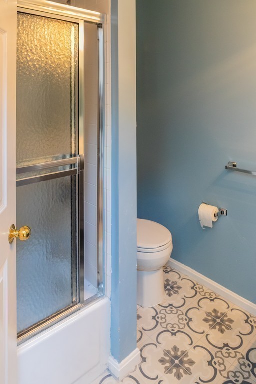 85 Bishops Forest Drive, Unit 85 Waltham, MA 02452 - Photo 23 of 32 a bathroom with a toilet and a shower