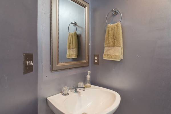 85 Bishops Forest Drive, Unit 85 Waltham, MA 02452 - Photo 9 of 32 a bathroom with a sink and a mirror