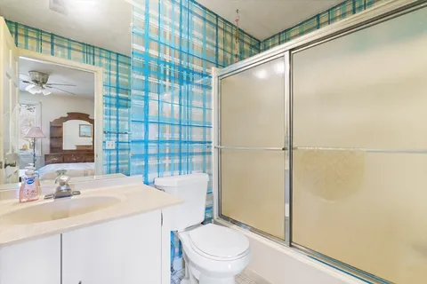 a bathroom with a sink toilet and shower