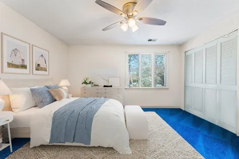 a bedroom with a large bed and a window