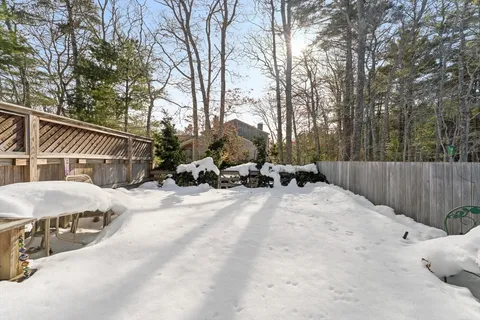 a view of backyard with table and chairs and a fire pit