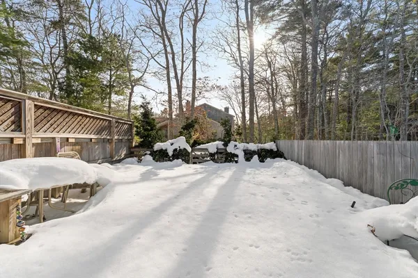 a view of backyard with table and chairs and a fire pit
