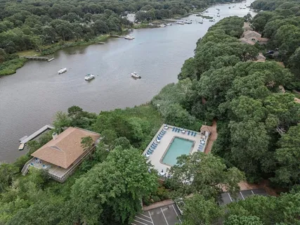 an aerial view of a house with yard and outdoor seating