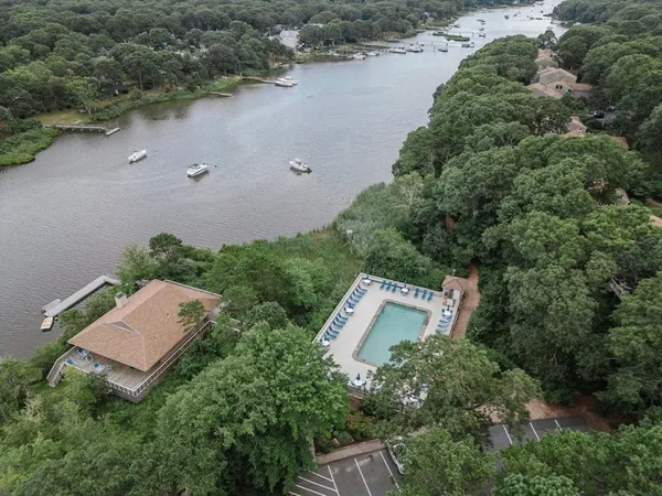 an aerial view of a house with yard and outdoor seating