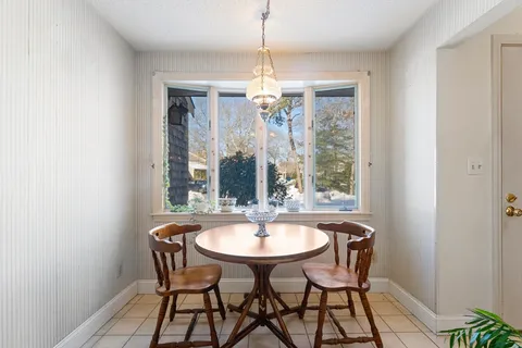 a dining room with furniture and window