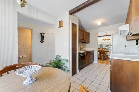 a kitchen with stainless steel appliances kitchen island granite countertop a refrigerator a stove a oven with white cabinets