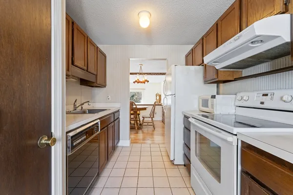 a kitchen with stainless steel appliances granite countertop a stove and a refrigerator