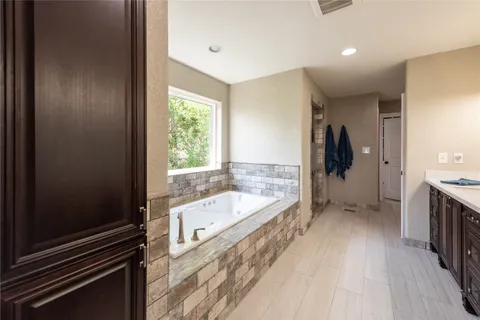 a spacious bathroom with a double vanity sink and a mirror