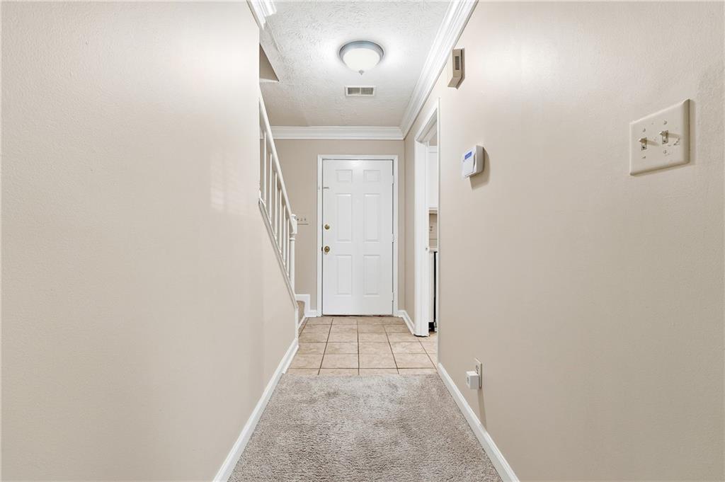 136 Sterling Court Alpharetta, GA 30004 - Photo 12 of 25 a view of a hallway with wooden floor and a mirror