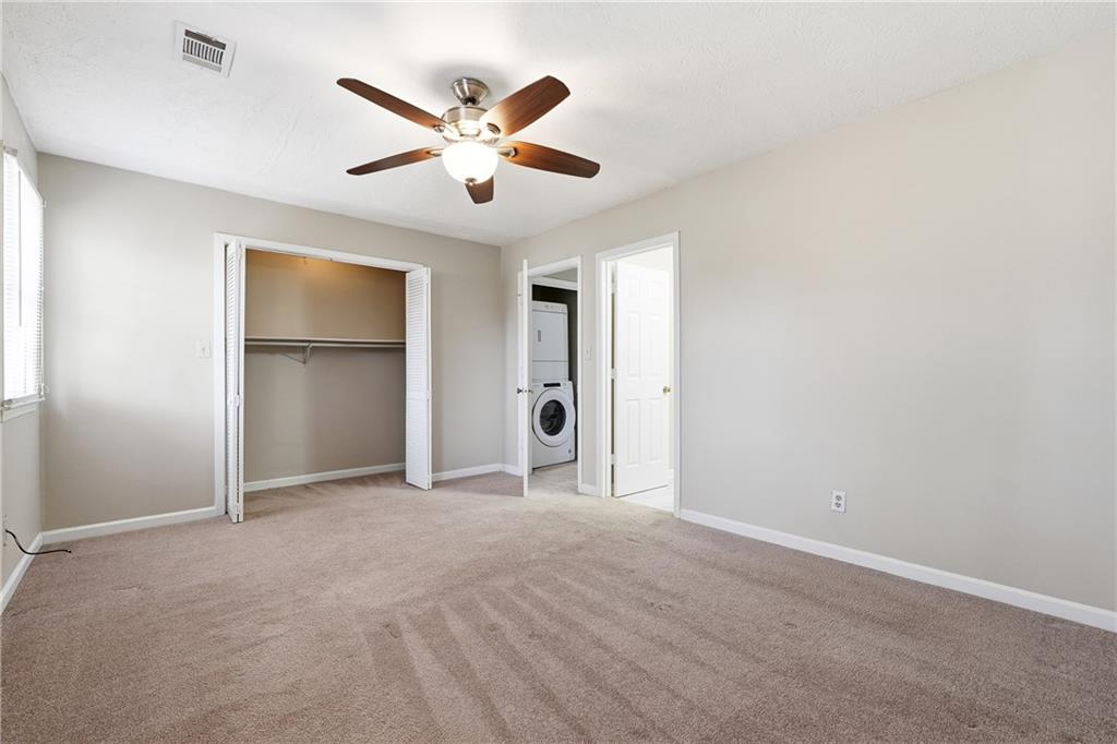 136 Sterling Court Alpharetta, GA 30004 - Photo 17 of 25 a view of an empty room with closet and a ceiling fan