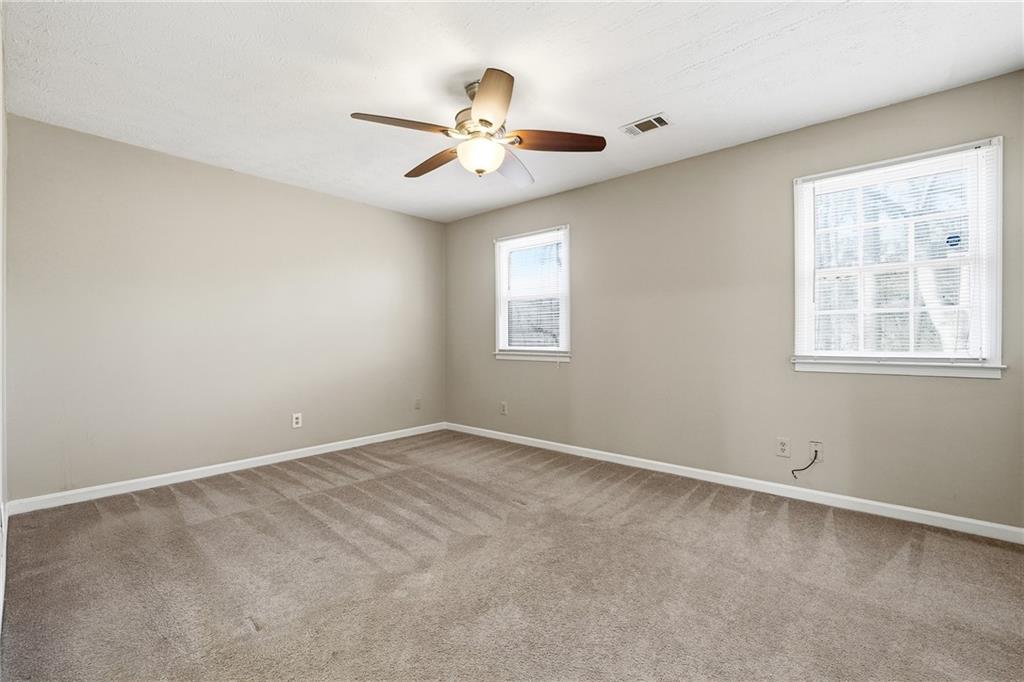 136 Sterling Court Alpharetta, GA 30004 - Photo 18 of 25 an empty room with windows and fan