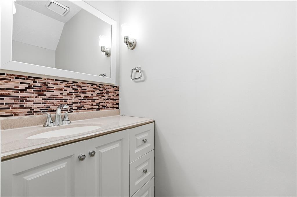 136 Sterling Court Alpharetta, GA 30004 - Photo 19 of 25 a bathroom with a sink and vanity