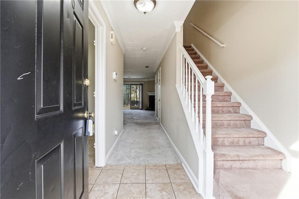 136 Sterling Court Alpharetta, GA 30004 - Photo 2 of 25 a view of a hallway with wooden floor and staircase