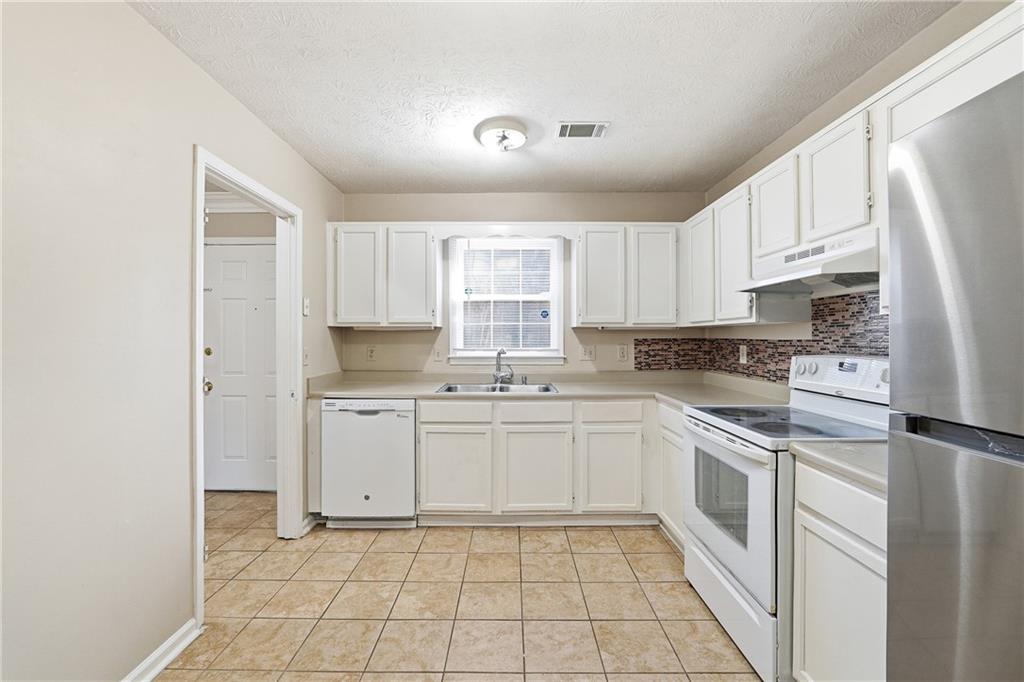 136 Sterling Court Alpharetta, GA 30004 - Photo 4 of 25 a kitchen with white cabinets appliances and a sink