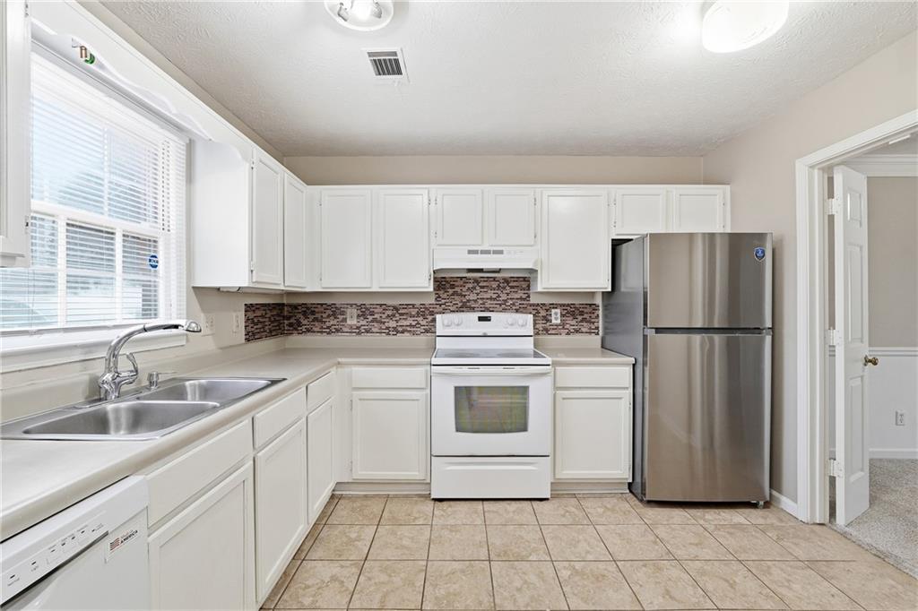 136 Sterling Court Alpharetta, GA 30004 - Photo 6 of 25 a kitchen with a refrigerator sink and cabinets