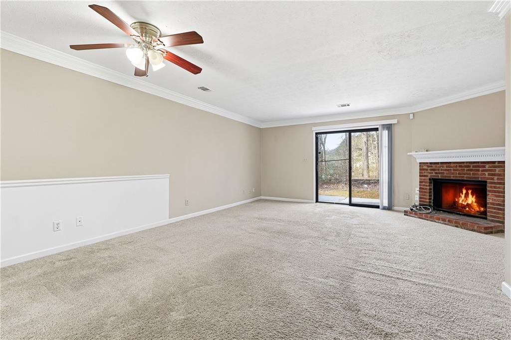 136 Sterling Court Alpharetta, GA 30004 - Photo 8 of 25 a view of an empty room with a fireplace
