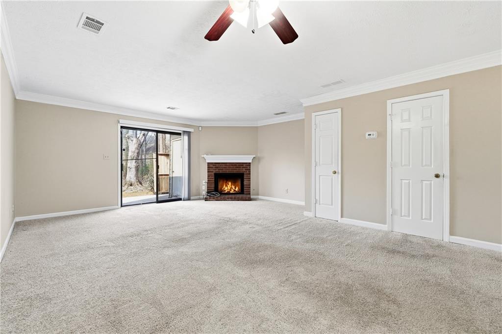 136 Sterling Court Alpharetta, GA 30004 - Photo 9 of 25 a view of an empty room with window and a fireplace