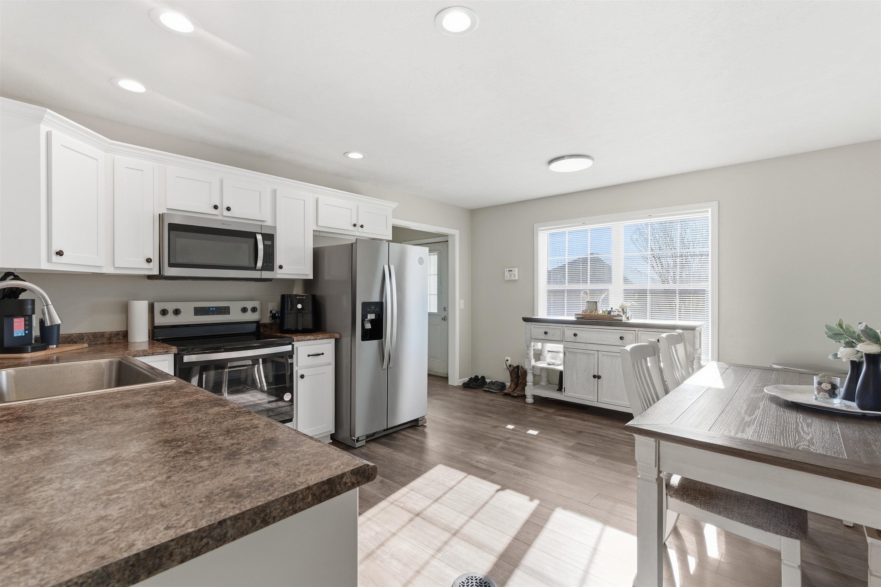 448 Stevens Road Bolivar, TN 38008 - Photo 11 of 25 Kitchen with stainless steel appliances, dark countertops, white cabinetry, and recessed lighting