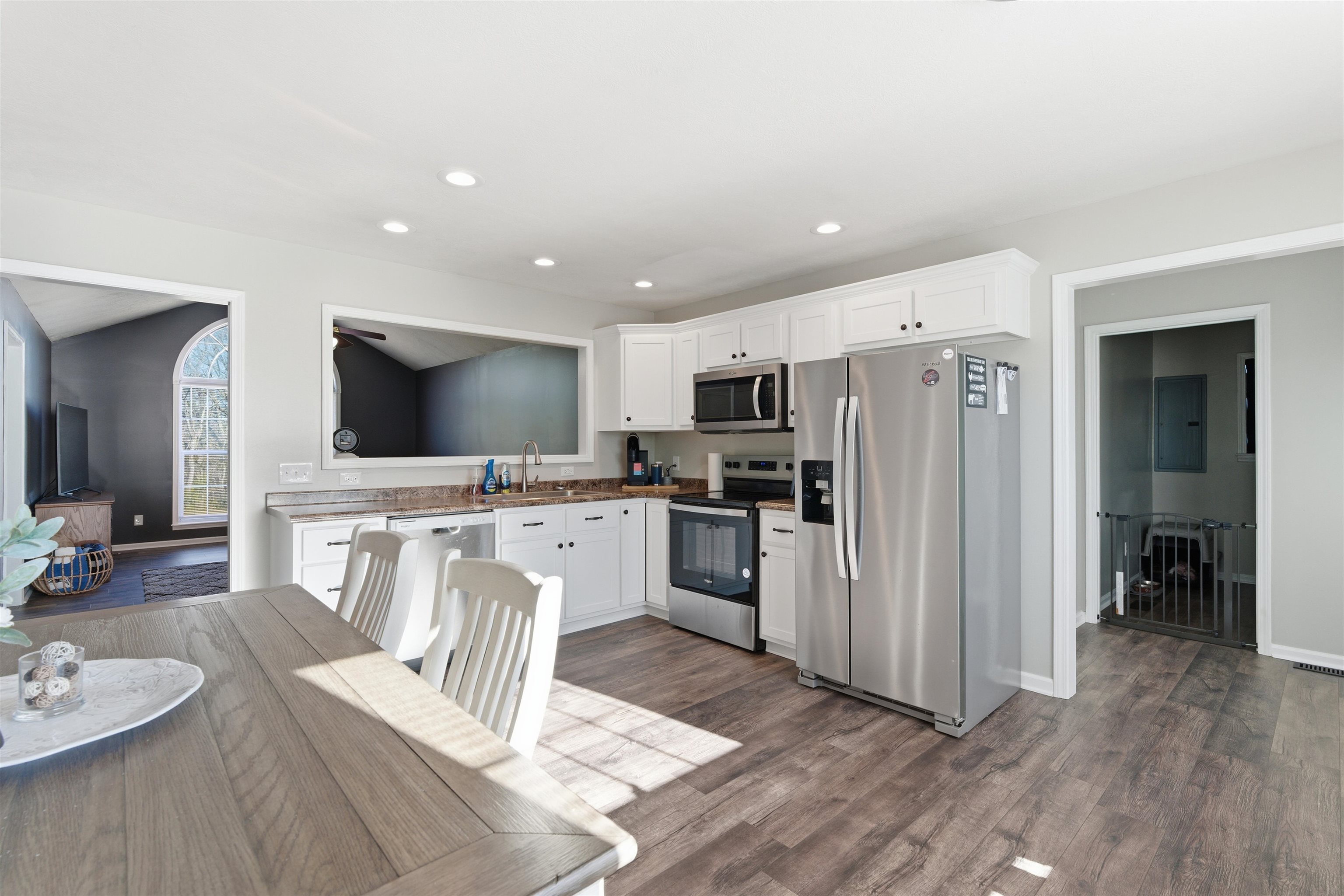 448 Stevens Road Bolivar, TN 38008 - Photo 12 of 25 Kitchen with stainless steel appliances, white cabinets, dark wood-style flooring, recessed lighting, and lofted ceiling