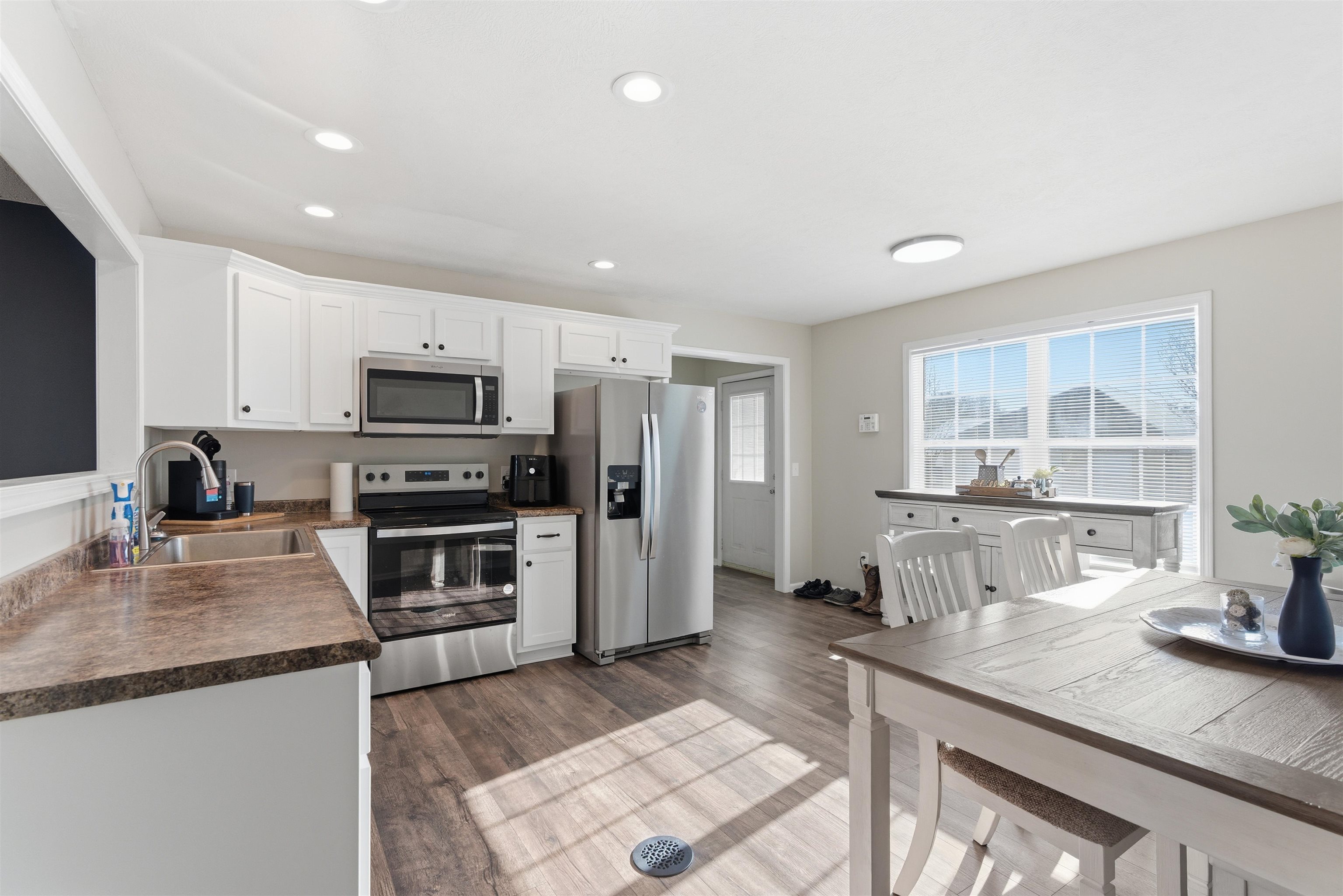 448 Stevens Road Bolivar, TN 38008 - Photo 14 of 25 Kitchen with dark countertops, stainless steel appliances, white cabinetry, dark wood-style floors, and recessed lighting