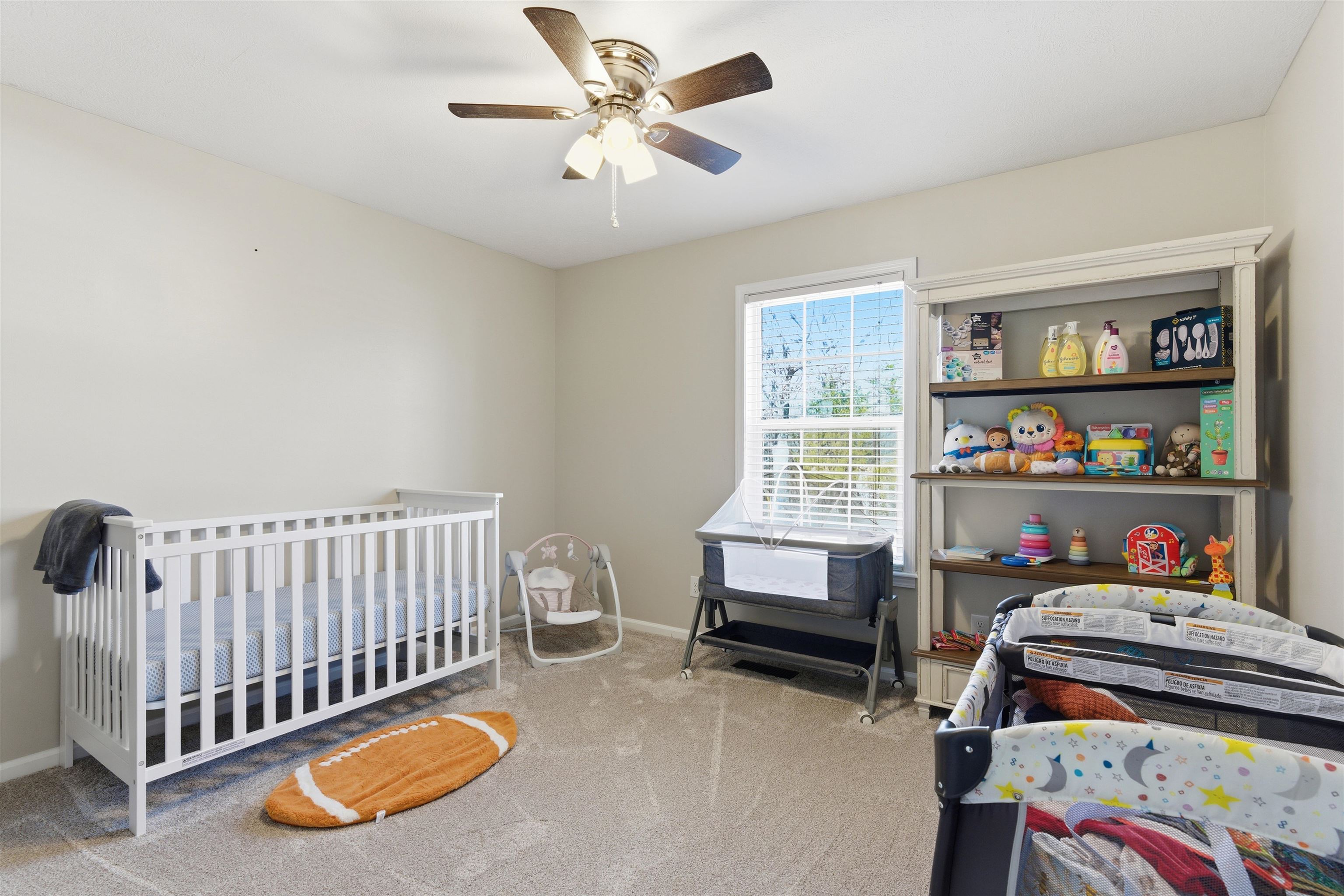 448 Stevens Road Bolivar, TN 38008 - Photo 17 of 25 Bedroom with a crib, light colored carpet, and a ceiling fan
