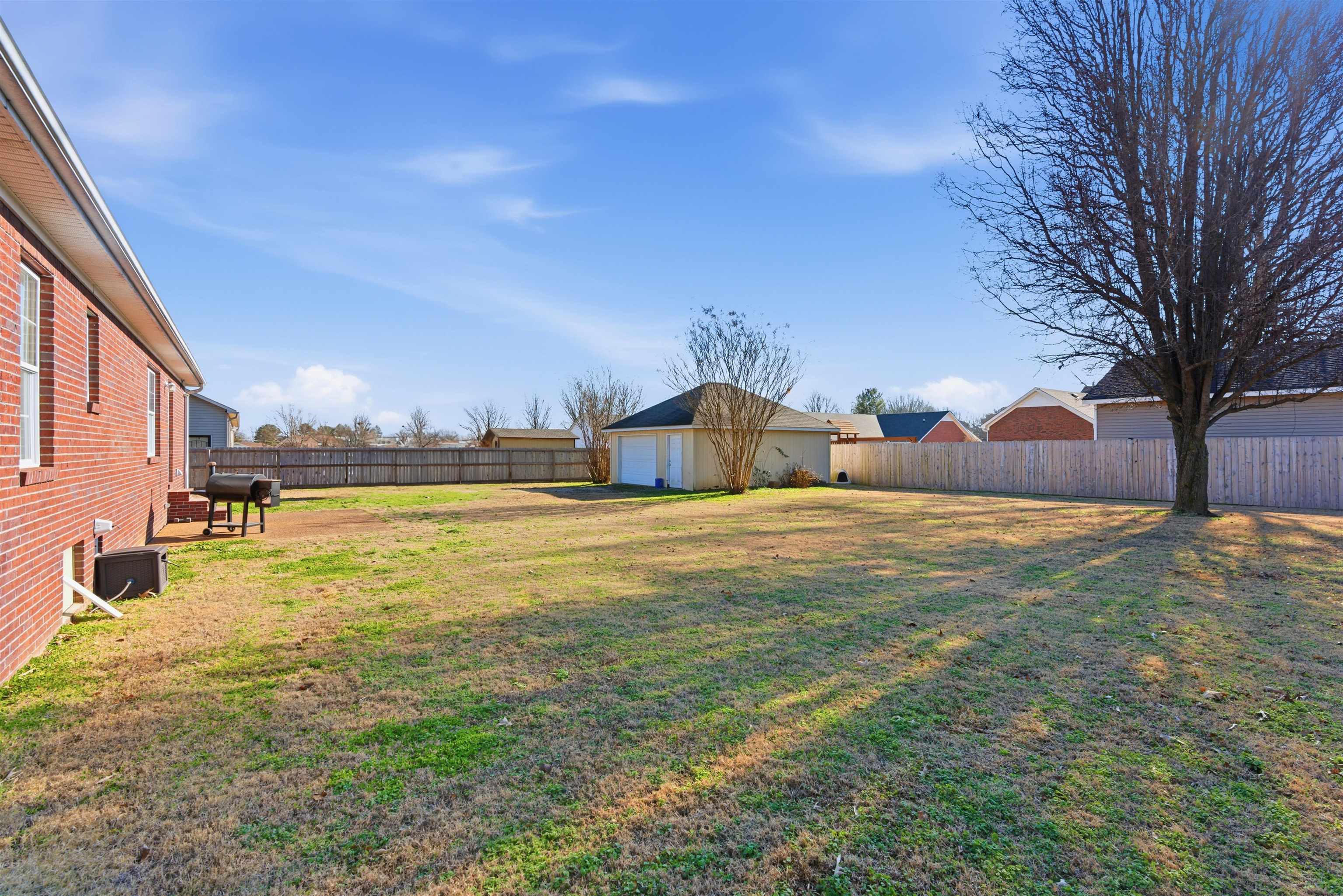 448 Stevens Road Bolivar, TN 38008 - Photo 5 of 25 Fenced backyard featuring an outbuilding and a patio