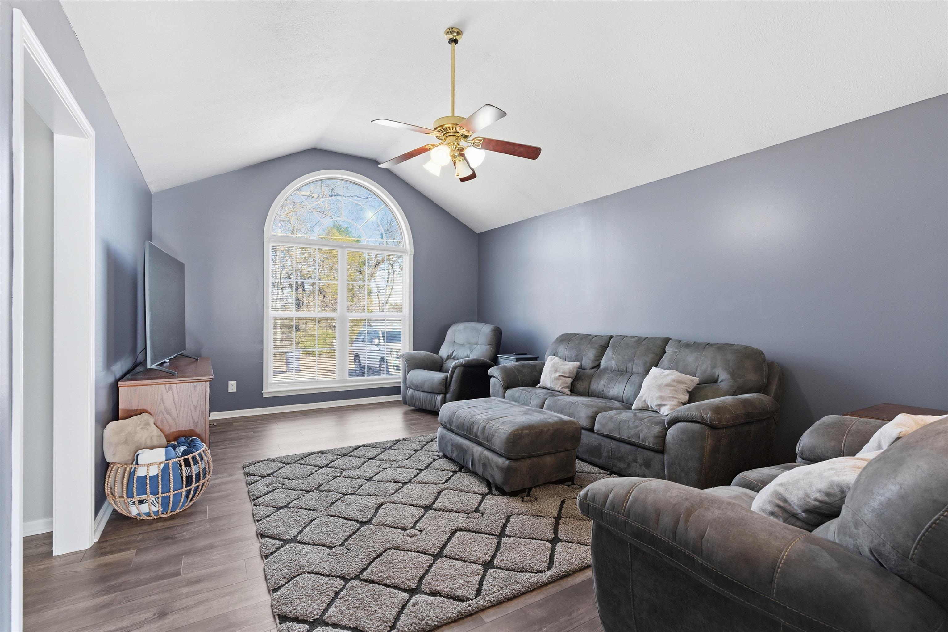 448 Stevens Road Bolivar, TN 38008 - Photo 10 of 25 Living room featuring a ceiling fan and dark wood-style floors