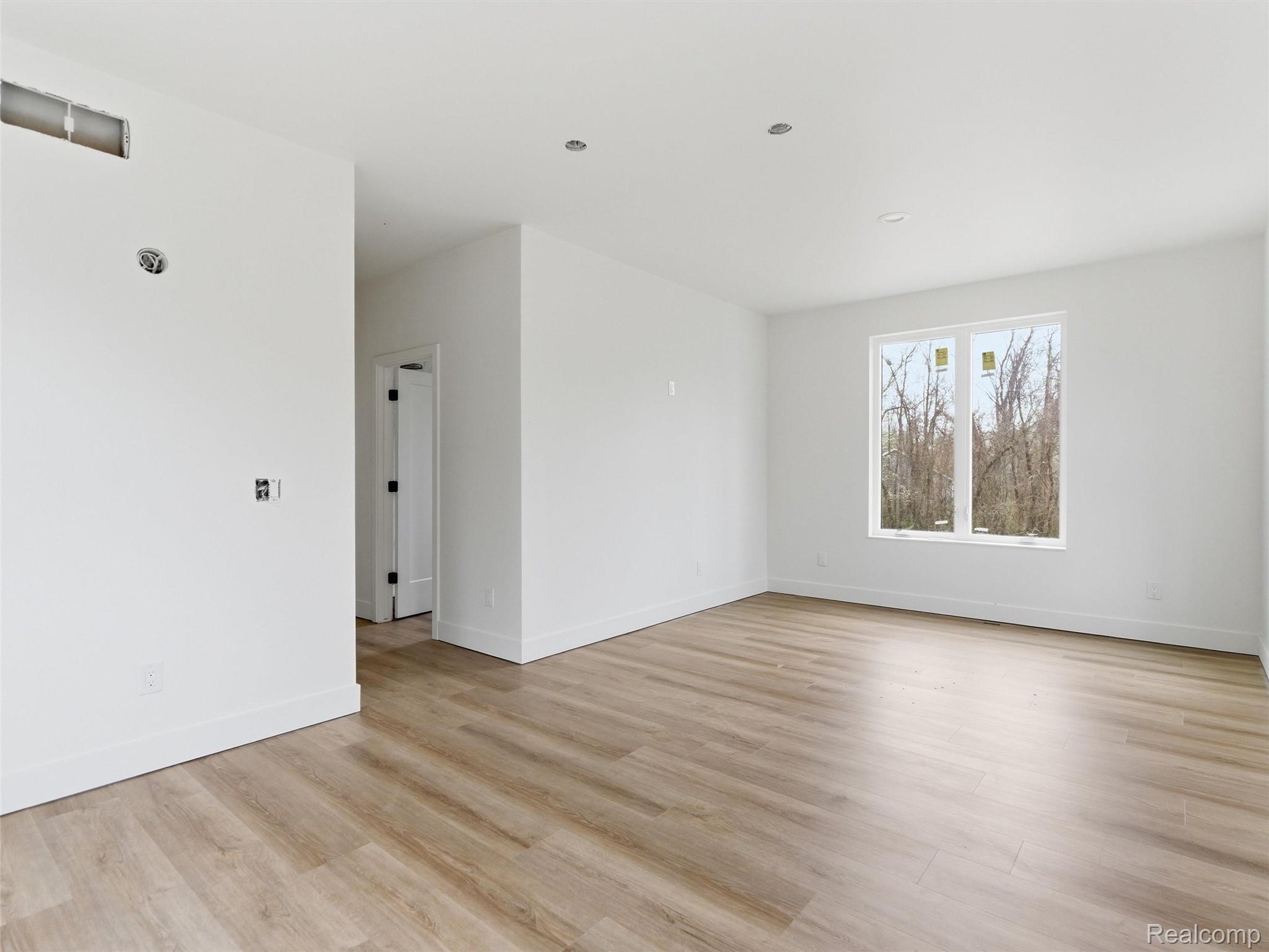 11810 Scenic Valley Road Davisburg, MI 48350 - Photo 20 of 46 Spare room featuring light wood-style floors and baseboards
